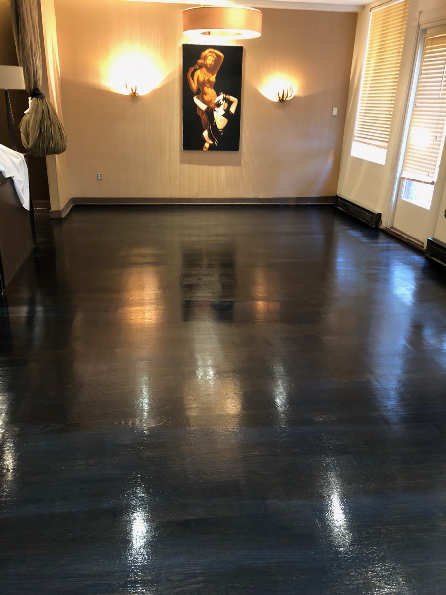 Hardwood floor after a dark stain and gloss finish